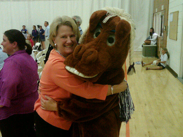 Barbara Wagner and Sally the Mustang embrace.