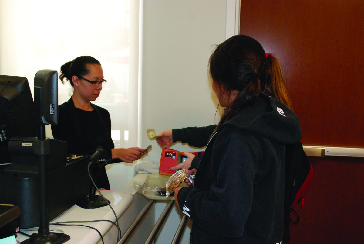 CARDS: Nora Saldizar collects a Marlborough students money in the cafeteria. Photo by Sophia Cardenas.