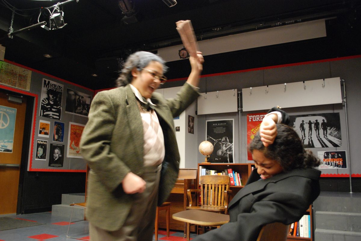 STUDENT CRACKDOWN: Sarah K. 11 beats a lesson into Dana 12 in the Drama Ensemble play, The History Boys. Photo by Celine 