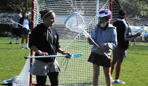 WOMENS LACROSSE: Students practice their lacrosse skills on the field. Photo by Chris Colthart. 