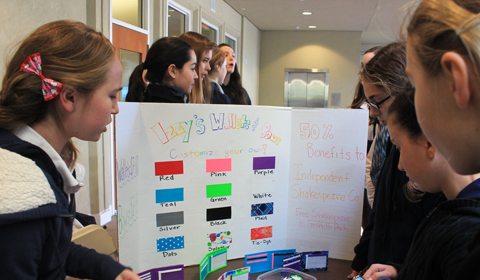 CRAFTY: Isabelle Bauman ’15 sells duct tape wallets at the Trade Fair. Photo by Caroline 13.