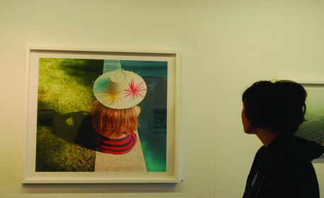 Maggie '15 gazes at one of the photographs in the Six Shooters exhibit. Photo by Ariella '15.