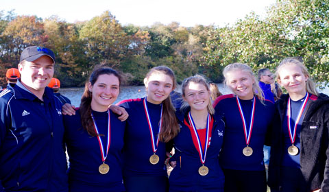 Genevieve '14 and her teammates show off their gold metals after winning first place in the Head of the Charles Regatta in Boston. Photo by 