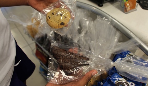 A student holds up the newly diminished in size Cafe M treats. Photo by Lori '14 