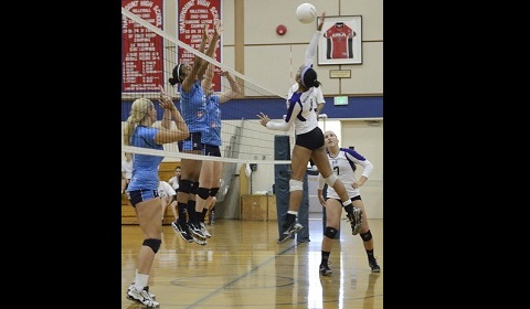 Elliott ’16 spikes a ball over her opponents during a game at Marymount High School. Photo by Rand Bleimeister.
