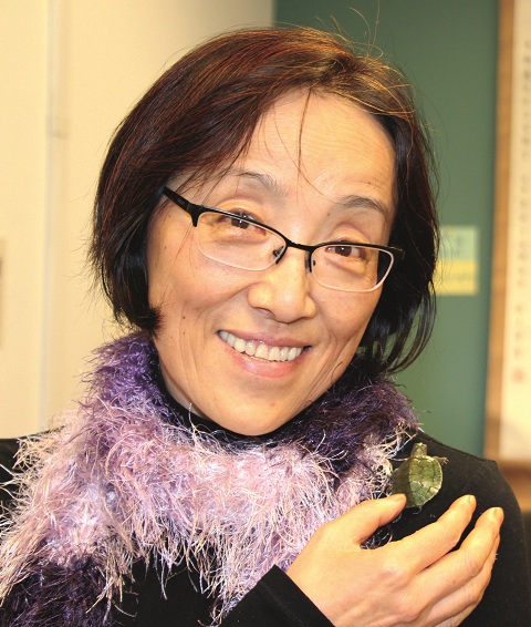 Foreign languages instructor Ling Zhang with a water turtle purchased on a Jan. 9 class trip to Chinatown. Xiao Zhang (Little Zhang) will remain in her classroom, C105, as a class pet.Photo by Lori '14.
