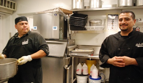 Carlos Rossel, left, shoots Head Chef Angel Guerro, right, a skeptical look as they work together in the kitchen. Photo by Kayleigh '18 / Staff Photographer