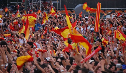 A crowd cheers for a celebracion in Madrid. photo by Flickr user cabezadeturco