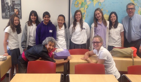 Seventh graders smile during a daily morning meeting with advisors Head of Middle School Robert Bryan and foreign languages instructor Margarita Llano and junior advisor Margaret '15. Photo by Sarah '16.