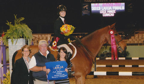 Cece '15 poses atop her prizewinning horse. Photo courtesy of Lori '14. 