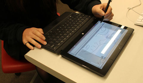 A girl uses one of the convertible tablet laptops. Photo by Maddy '15.