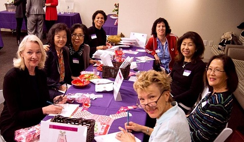 Moms pack Valentines Day care packages with notes, candy and love for recent alumnae. Photo by Rand Bleimeister.