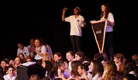 Ellie 16 and Lindsey 16 present the Class of 2016s sky-themed banner. Photo courtesy of Chris Colthart.