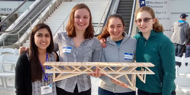 Caroline '18, Anne-Marie '18, Bridget and Anisha '16 pose with their bridge at the competition. 