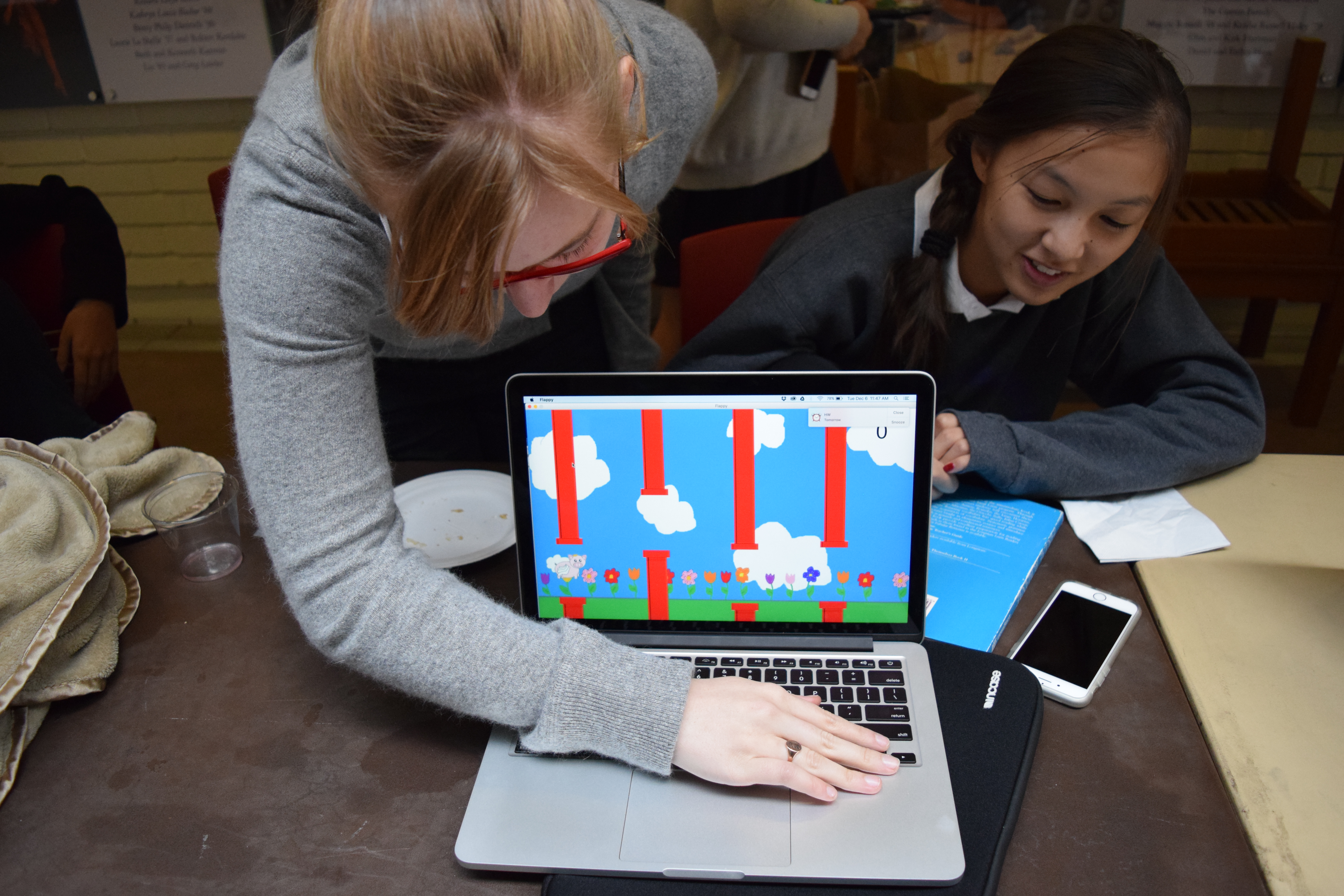 Sarah '18 and Car '17 demonstrate a flying pig game based on flappybird.