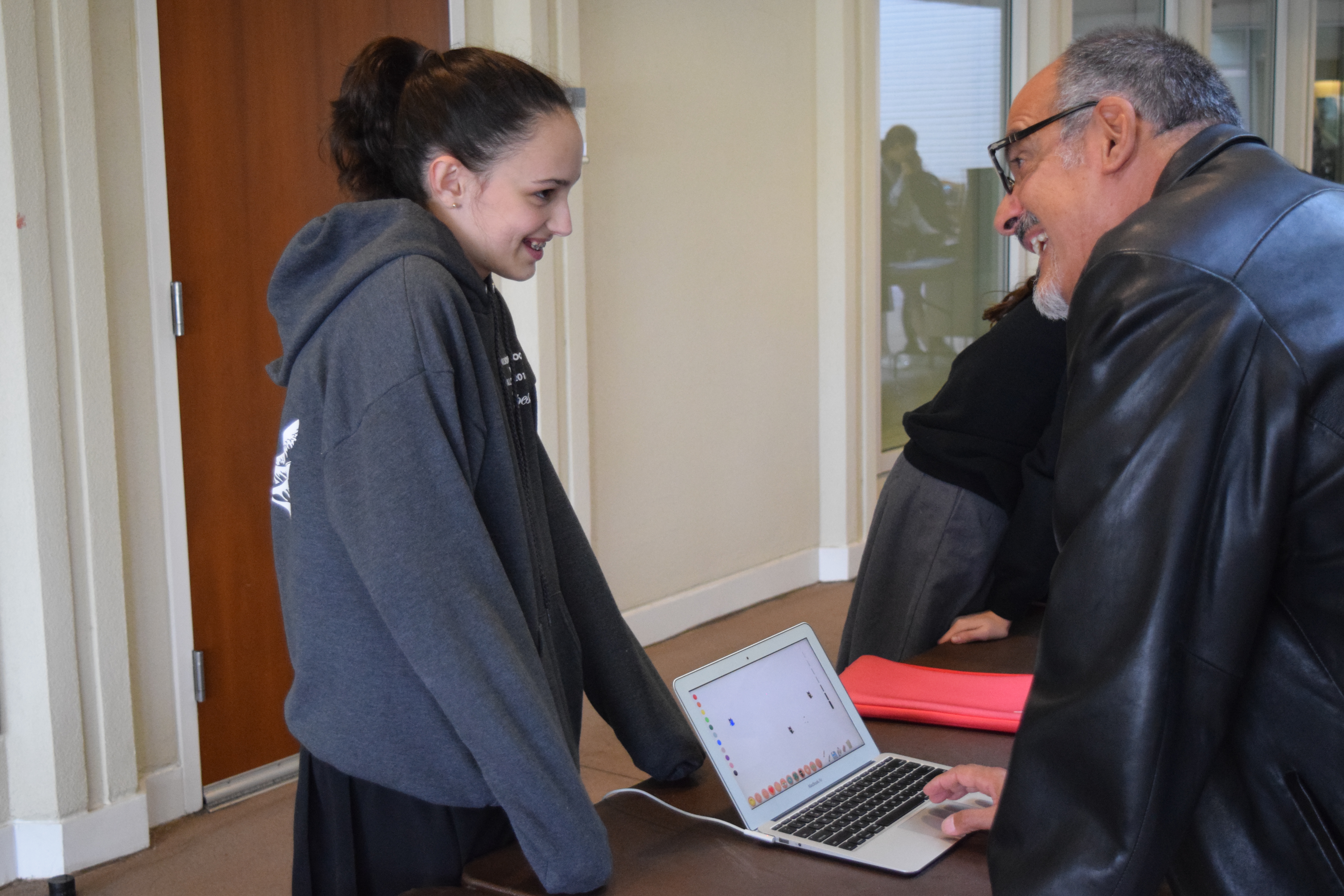 Allison '19 explains her project to World Languages instructor Victor Ortiz.