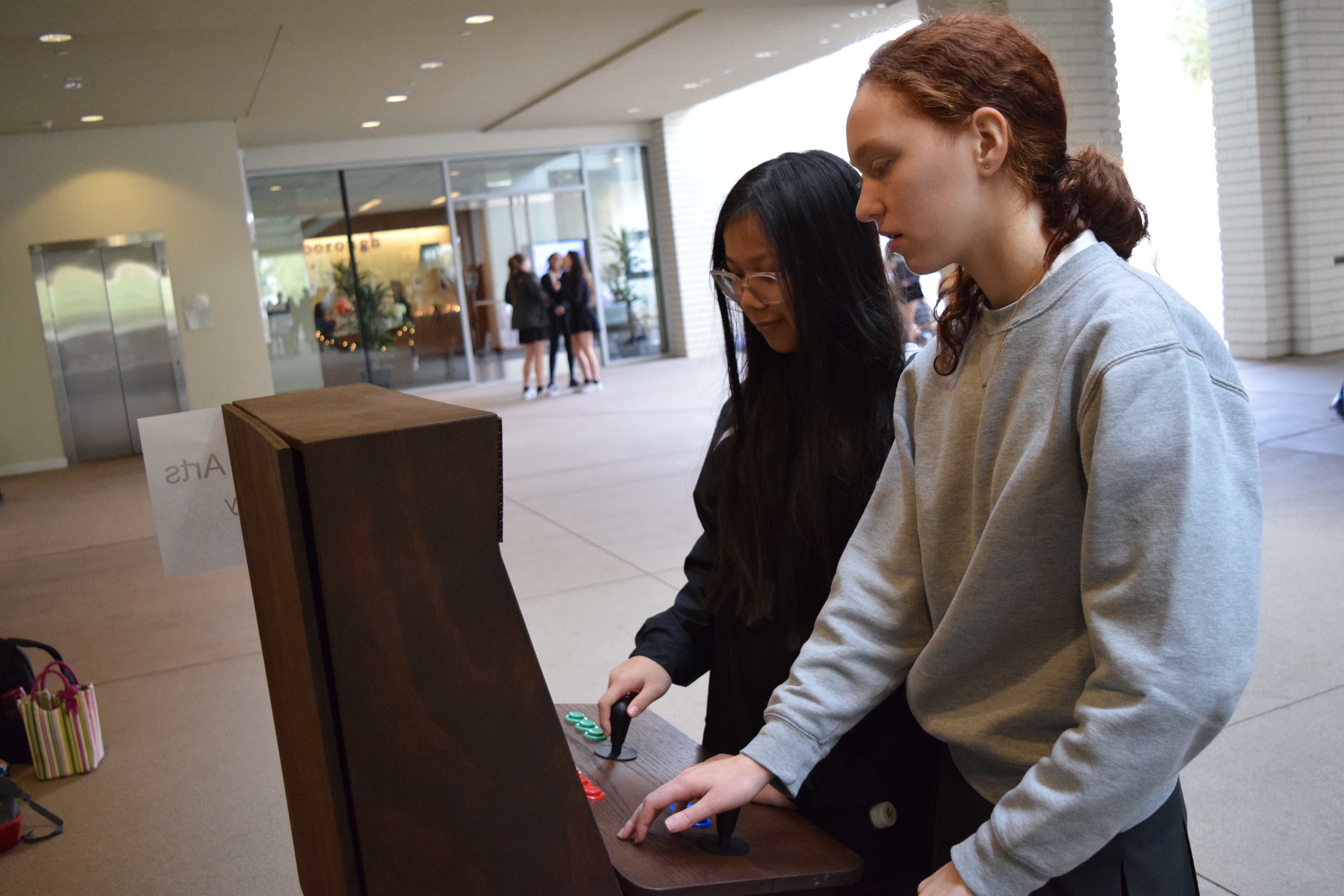 Paulina '18 and Hazel '18 play an arcade-style game created by math instructor Darren Kessner.