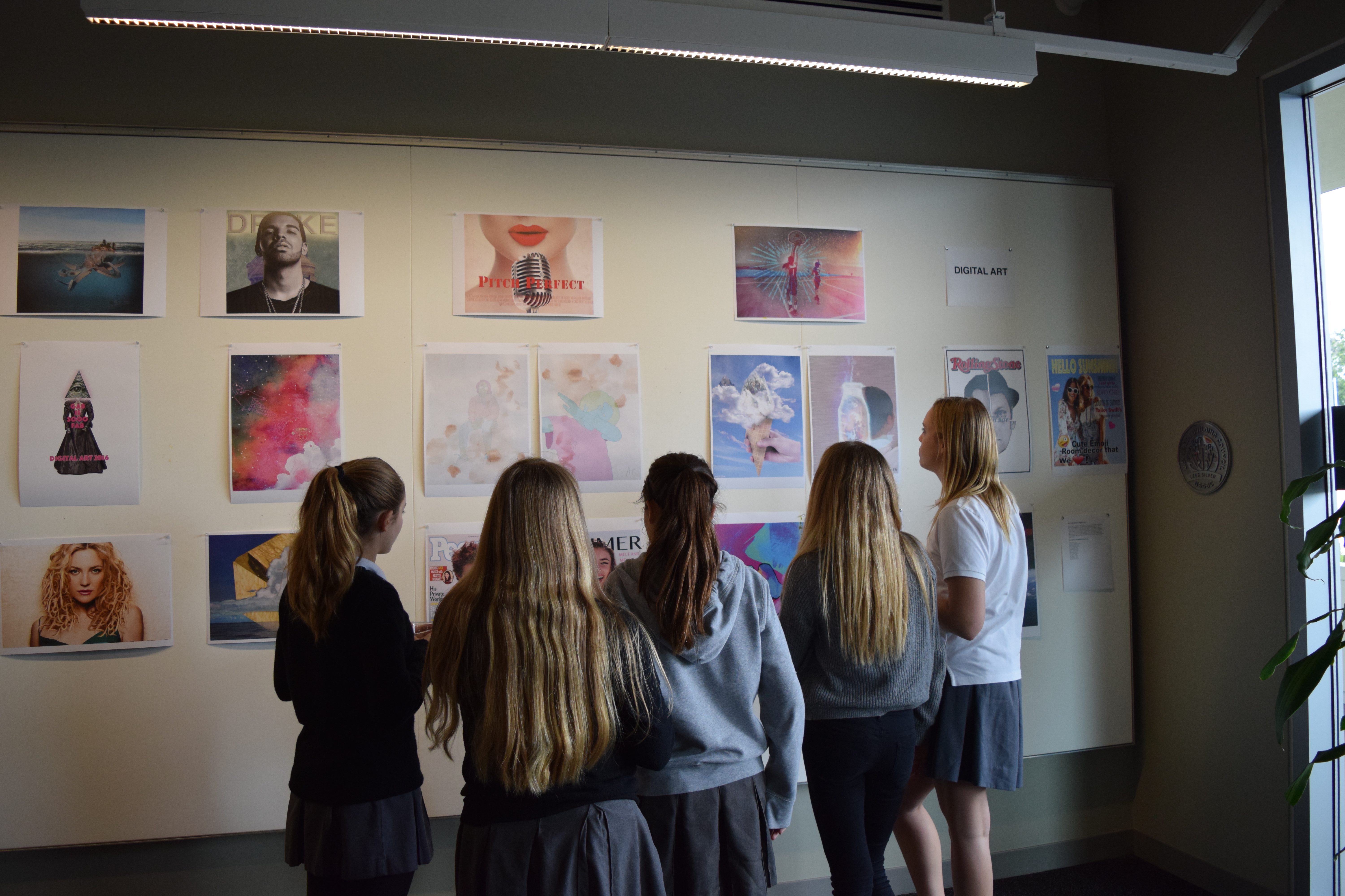 Students admire digital art.
