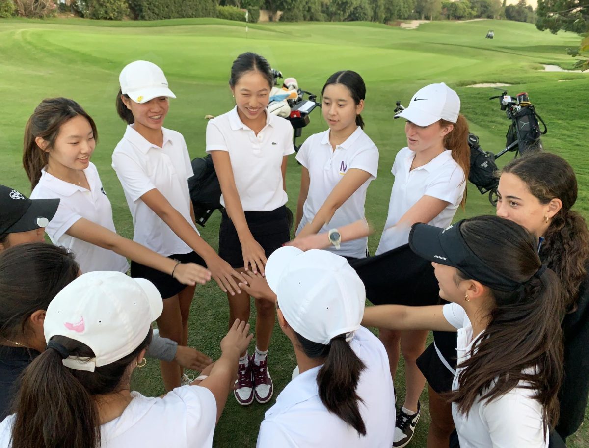 The+Varsity+golf+team+huddles+after+a+league+match.+Aleigha+Beavan-Szabo+Contributing+Photographer.