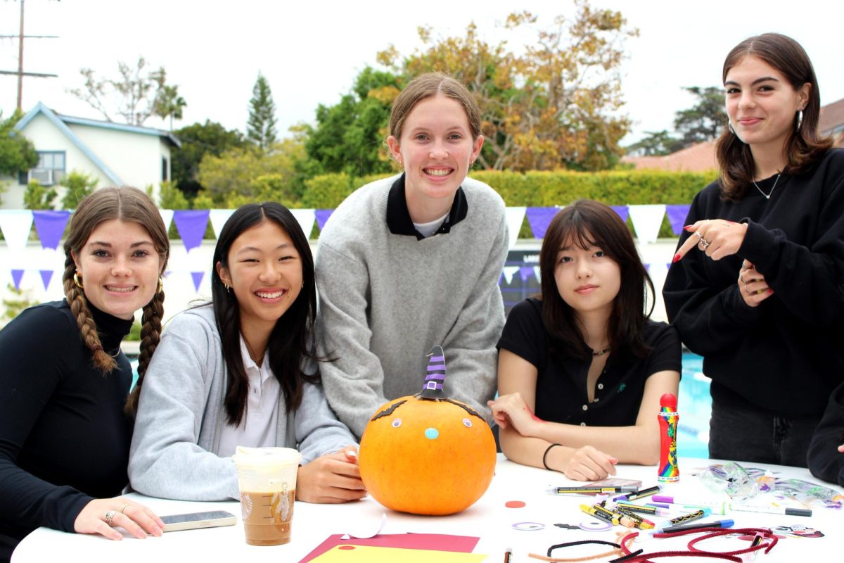Emma ‘25, Kira ‘28, Channing ‘25, Mia Cuomo ‘25 and Caroline ‘25 decorate a pumpkin for the buddy event.