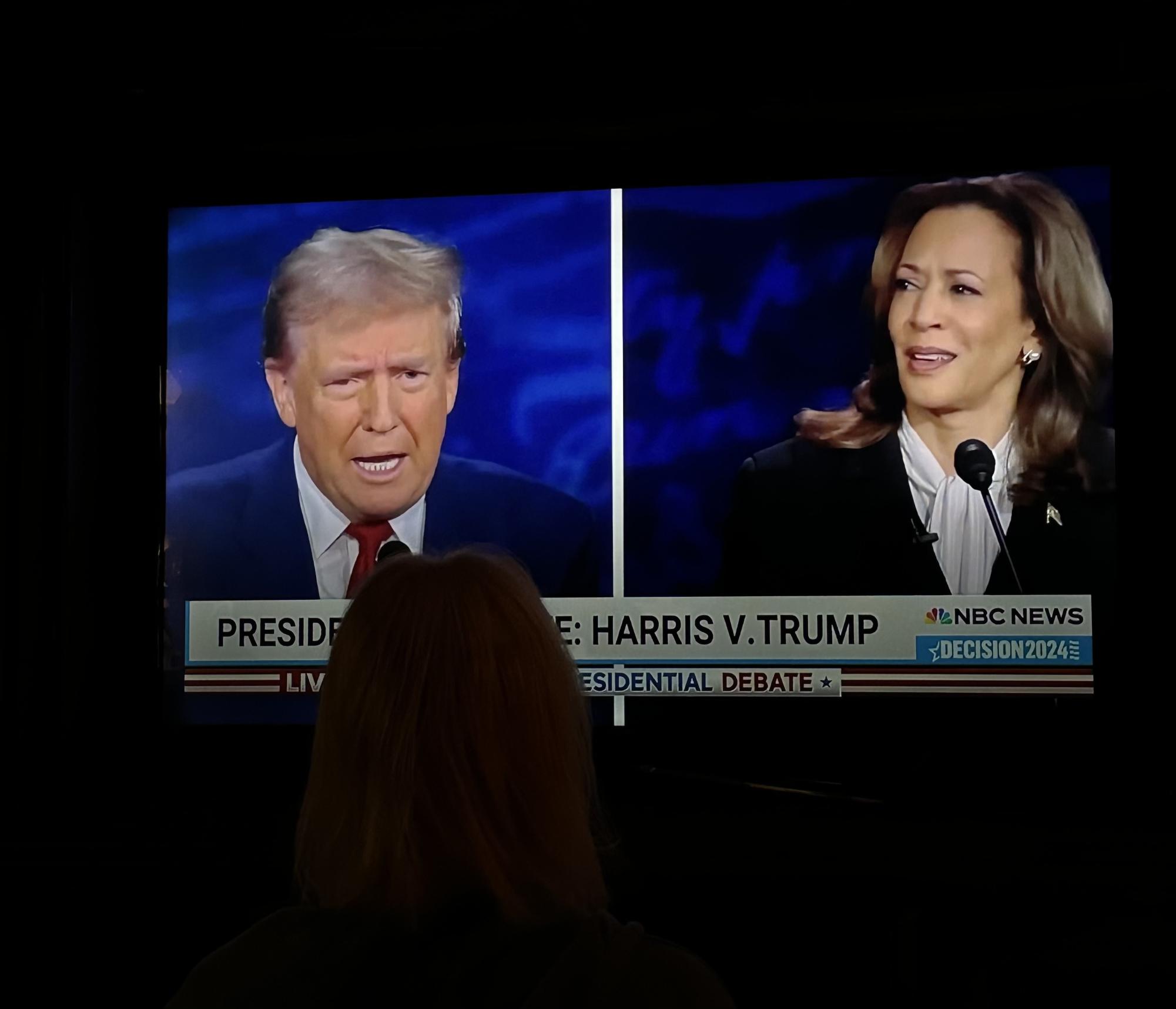 Americans sit at home and watch the Presidential Debate. 