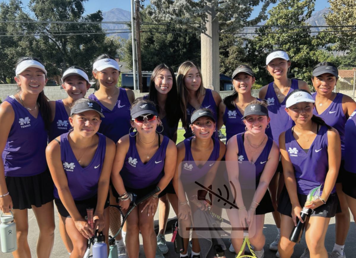 The varsity tennis team smiles for a photo before a tennis match.