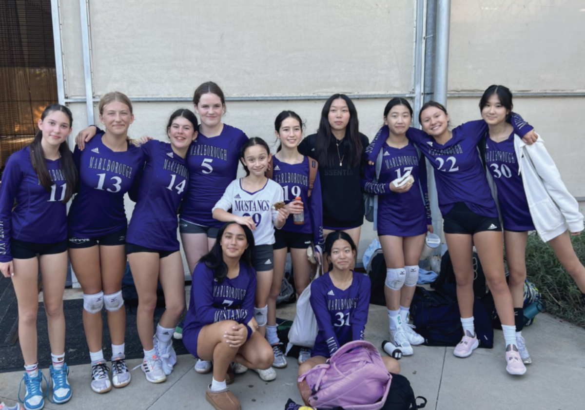 Members of the purple middle school team smile for a photo.