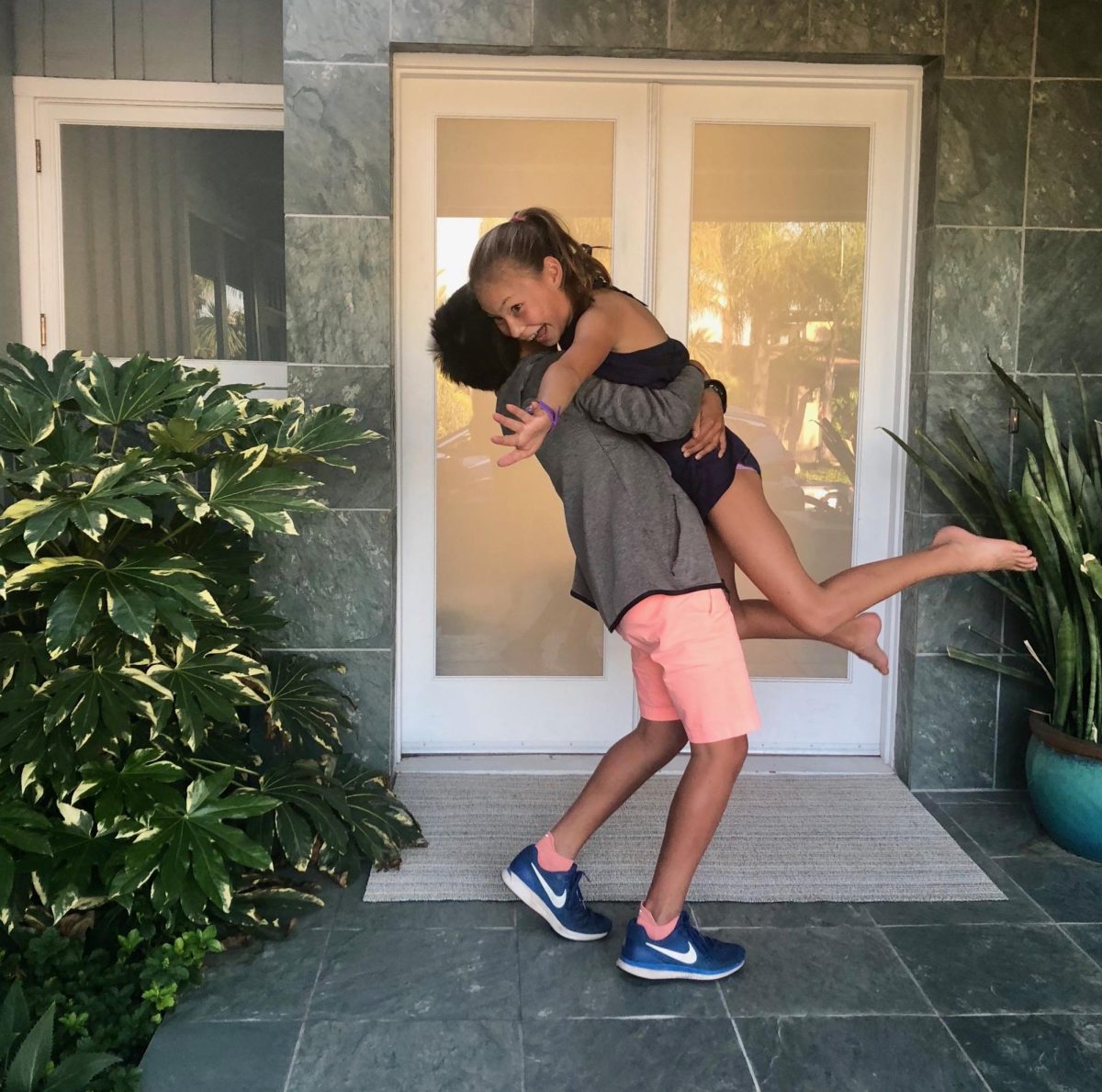 Cara '26 and her brother Owen play outside their home in 2018. 