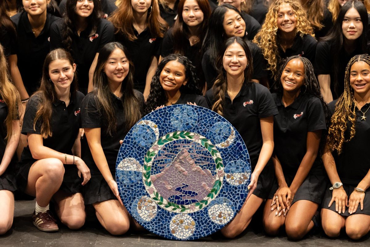 The Class of 2028 holds up their mosaic at the banner ceremony.